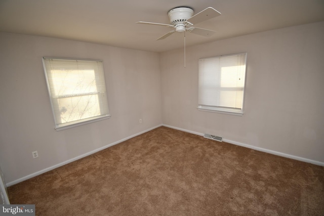 carpeted empty room featuring ceiling fan