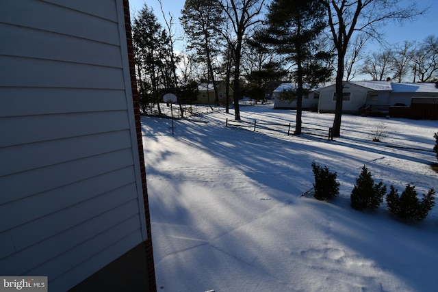 view of yard layered in snow