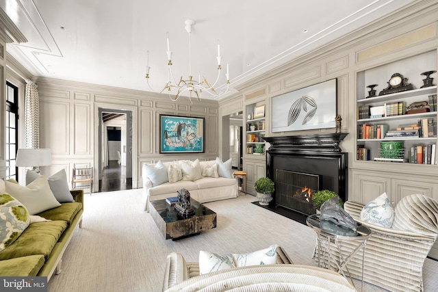 living room with light carpet, built in features, ornamental molding, and a notable chandelier