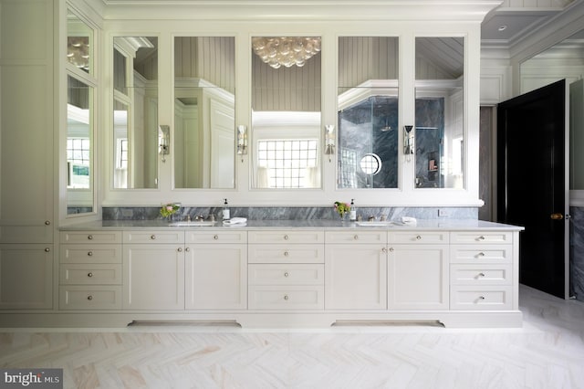 bathroom featuring ornamental molding, vanity, and parquet floors