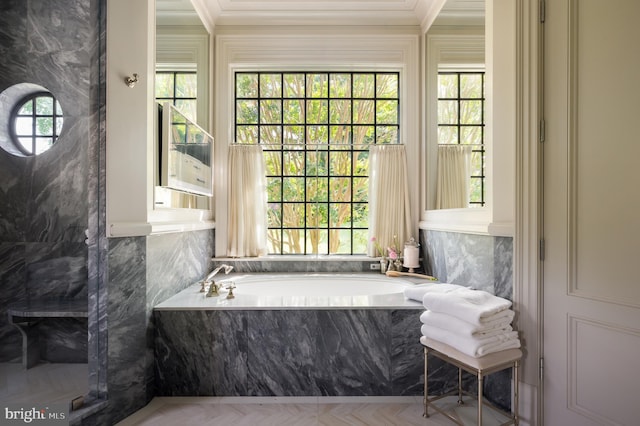 bathroom featuring tiled bath, parquet flooring, and crown molding