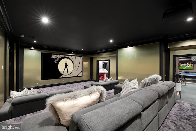 carpeted cinema room with ornamental molding