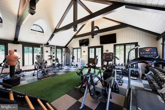 gym with carpet, wood walls, and high vaulted ceiling