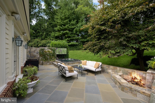 view of patio / terrace featuring an outdoor living space with a fire pit