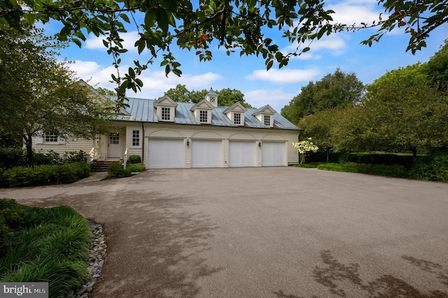 cape cod-style house featuring a garage