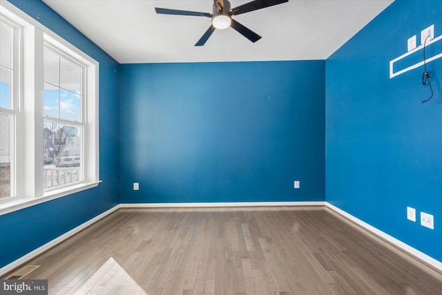 empty room with light hardwood / wood-style floors and ceiling fan