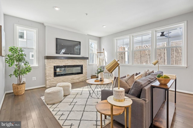 living room featuring a healthy amount of sunlight, a fireplace, and hardwood / wood-style floors