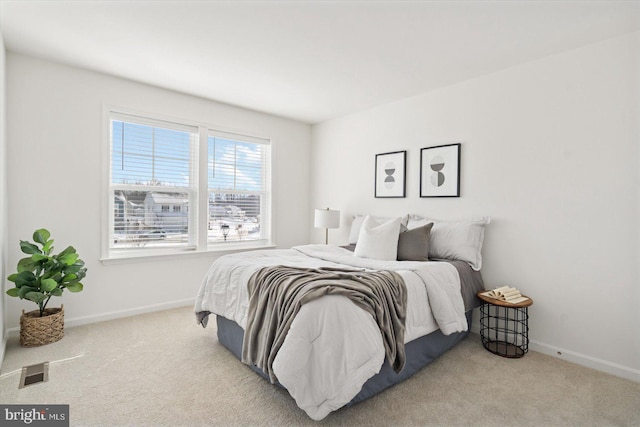 bedroom featuring light colored carpet