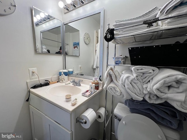 bathroom featuring vanity and toilet