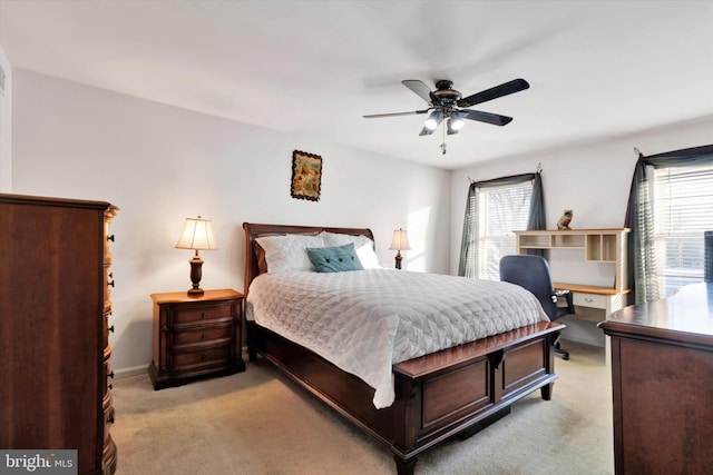 bedroom featuring light carpet and ceiling fan