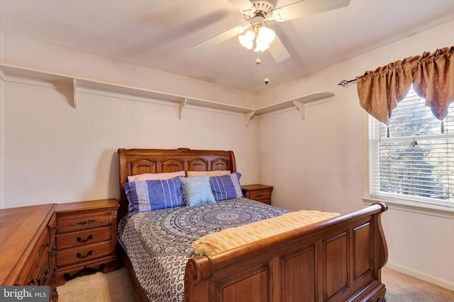 carpeted bedroom with multiple windows and ceiling fan