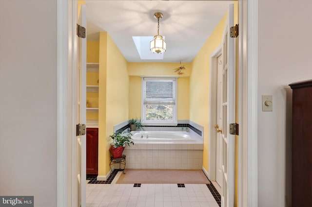 bathroom with tiled tub and tile patterned flooring