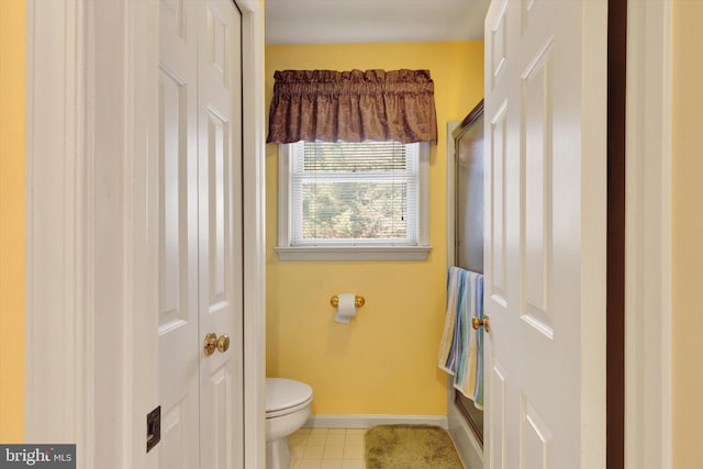 bathroom featuring toilet and tile patterned flooring