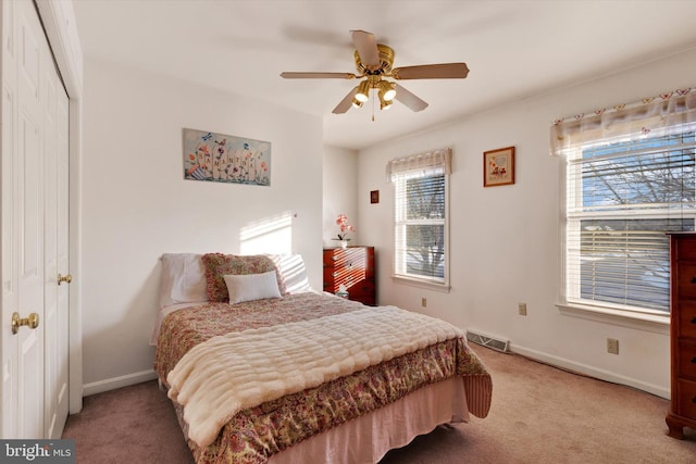 bedroom with ceiling fan, a closet, and carpet