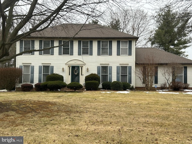 colonial home with a front lawn