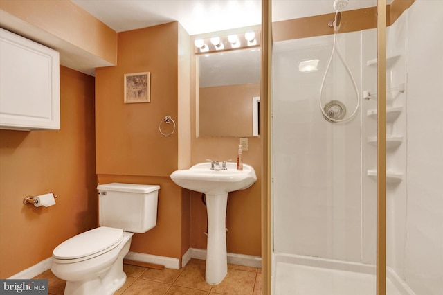 bathroom with tile patterned flooring, a shower, and toilet