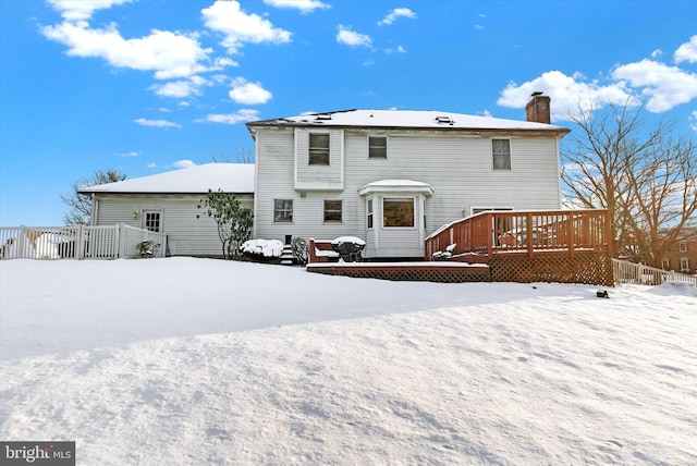 snow covered property featuring a wooden deck