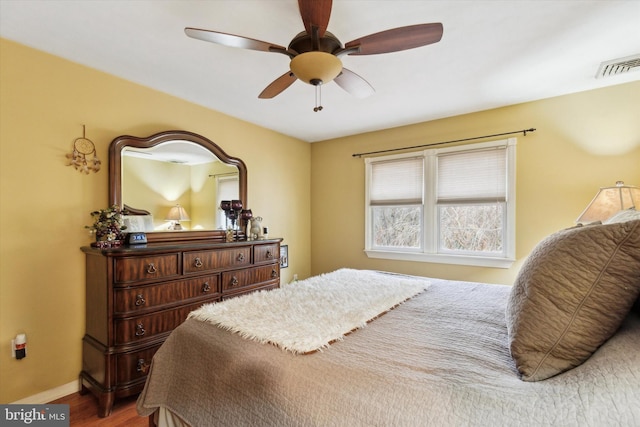 bedroom with ceiling fan and wood-type flooring