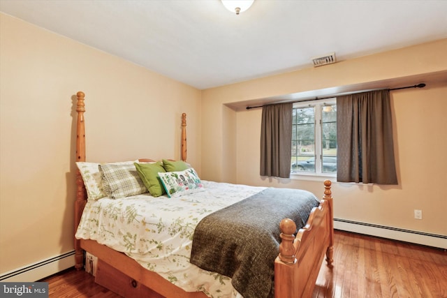 bedroom featuring a baseboard radiator and wood-type flooring