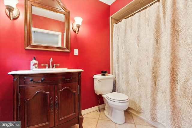 bathroom featuring toilet, vanity, and tile patterned flooring