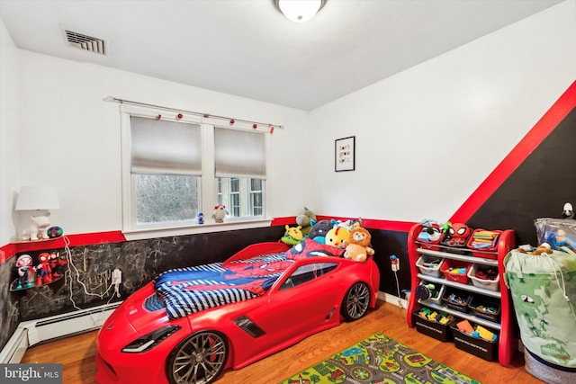 bedroom with hardwood / wood-style flooring