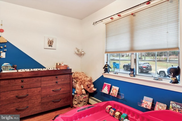 bedroom featuring a baseboard heating unit