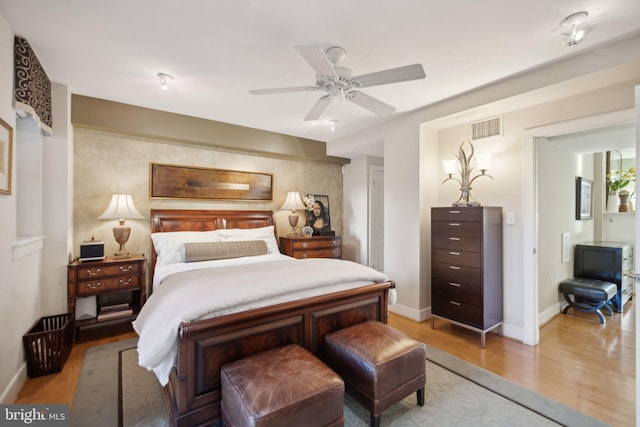 bedroom with ceiling fan and light hardwood / wood-style flooring