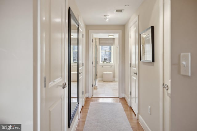 hallway with light wood-type flooring