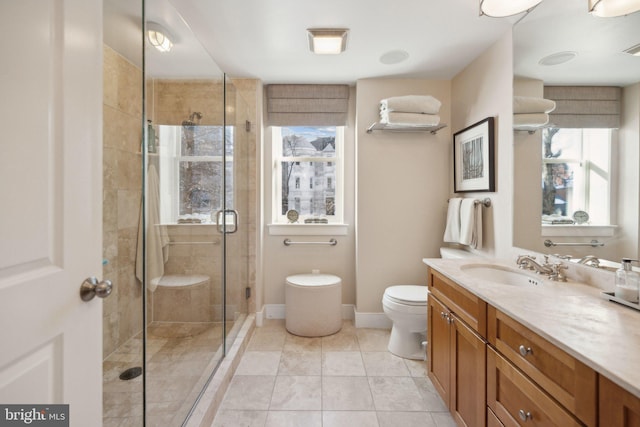 bathroom featuring vanity, toilet, tile patterned floors, and walk in shower