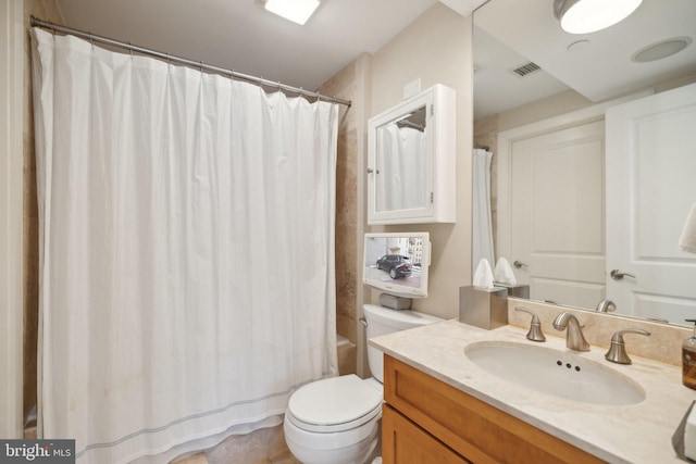 bathroom featuring toilet and vanity