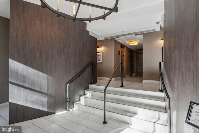 staircase featuring a high ceiling and tile patterned floors