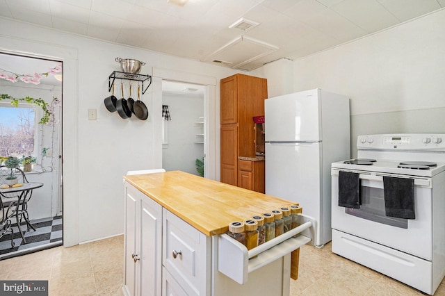 kitchen with white cabinetry and white appliances