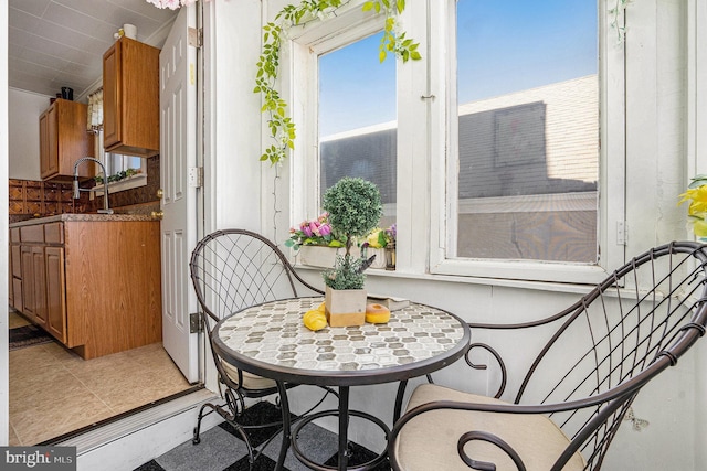 dining space featuring tile patterned flooring and sink