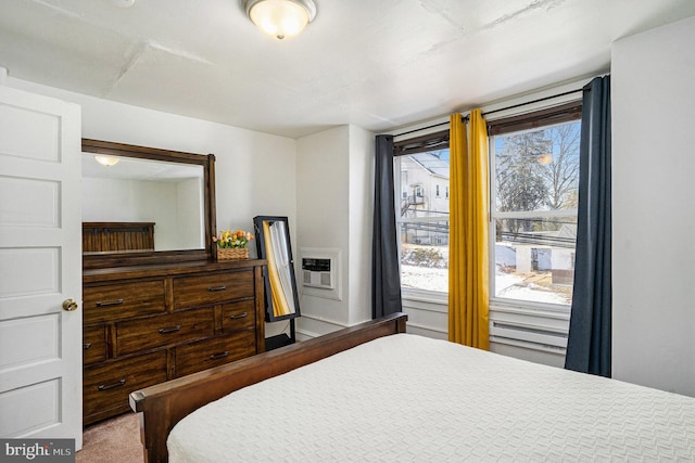 bedroom with an AC wall unit and carpet