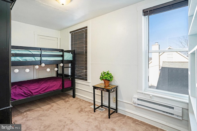 carpeted bedroom featuring a baseboard radiator