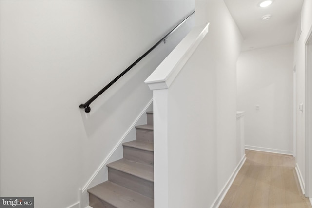 staircase with wood-type flooring