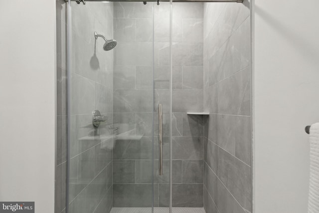 bathroom with a shower with shower door