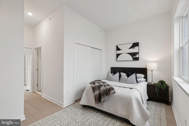 bedroom featuring a closet and light wood-type flooring