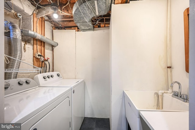 laundry area with washer and clothes dryer and a sink