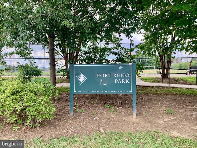 community / neighborhood sign with fence