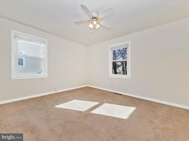 empty room featuring ceiling fan and carpet flooring