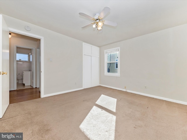 carpeted empty room with plenty of natural light and ceiling fan