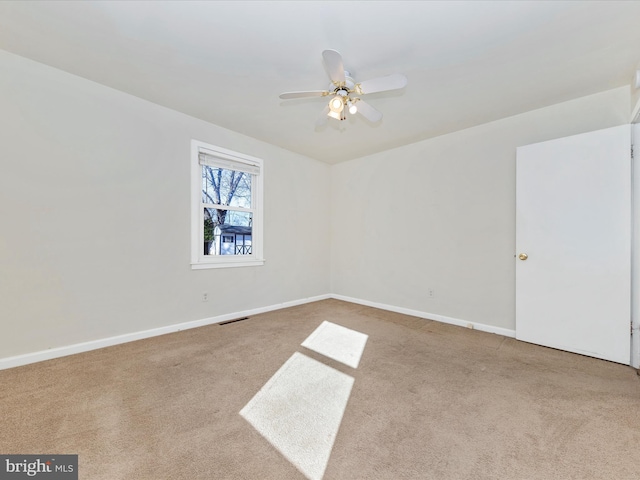 unfurnished room with light carpet and ceiling fan