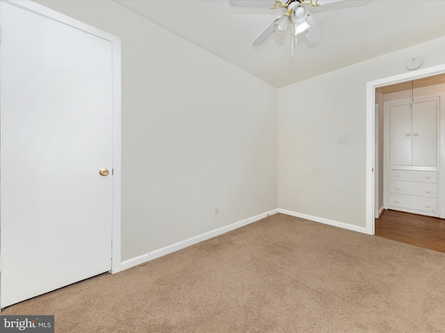 unfurnished bedroom featuring ceiling fan and carpet