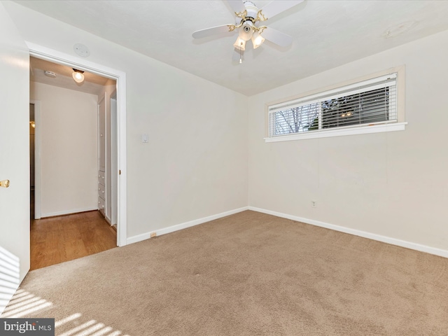 carpeted empty room with ceiling fan