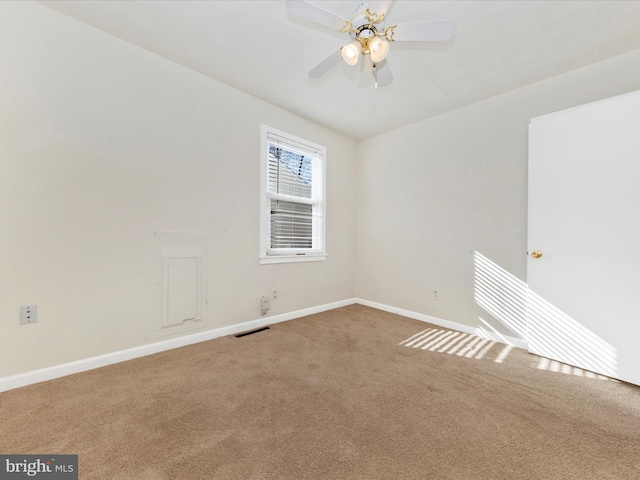 spare room with ceiling fan and carpet floors