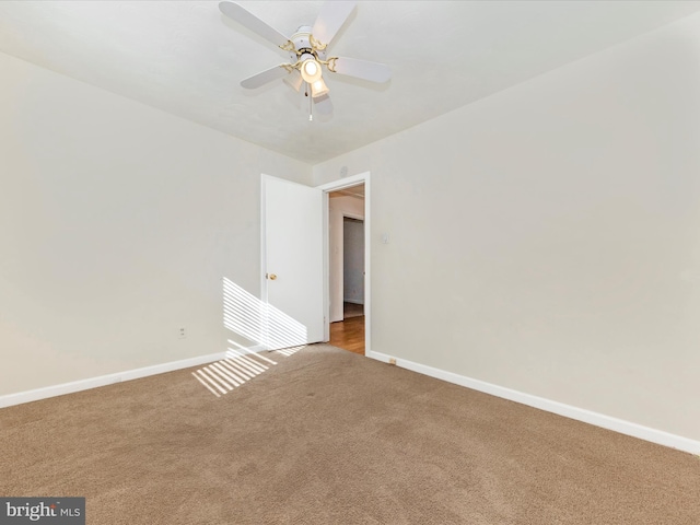 empty room featuring carpet floors and ceiling fan