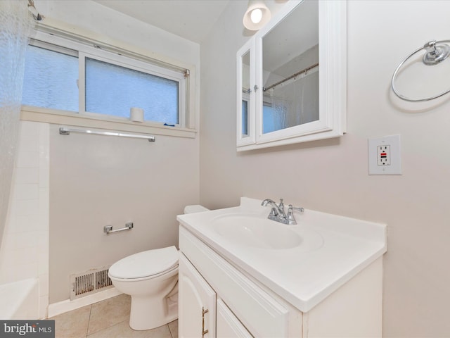 bathroom featuring vanity, tile patterned floors, and toilet