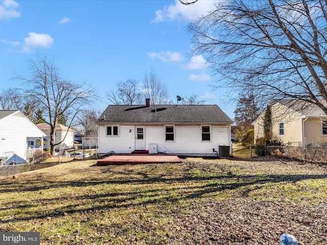 back of house featuring a wooden deck, central AC unit, and a lawn