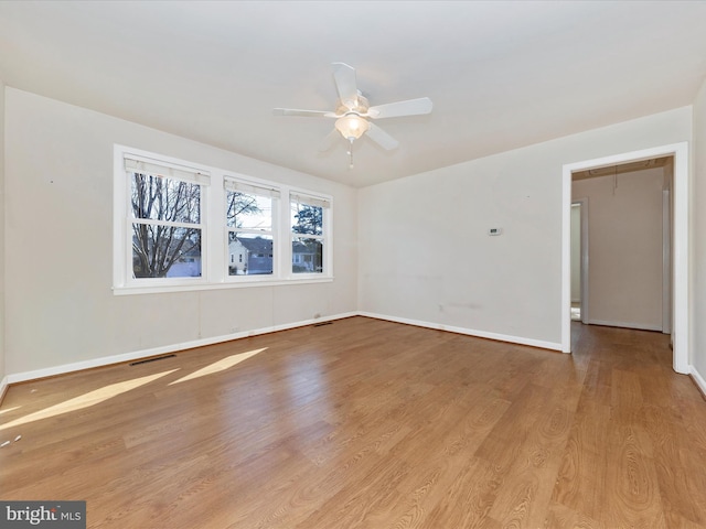 spare room featuring ceiling fan and light wood-type flooring